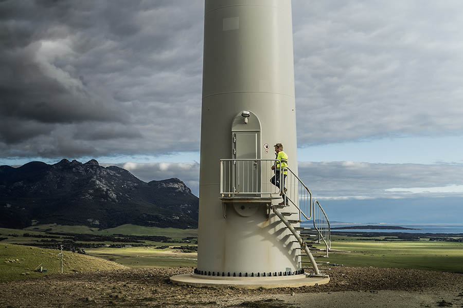 Hydro Tasmania worker Aronn climbing the stairs to a wind turbine
