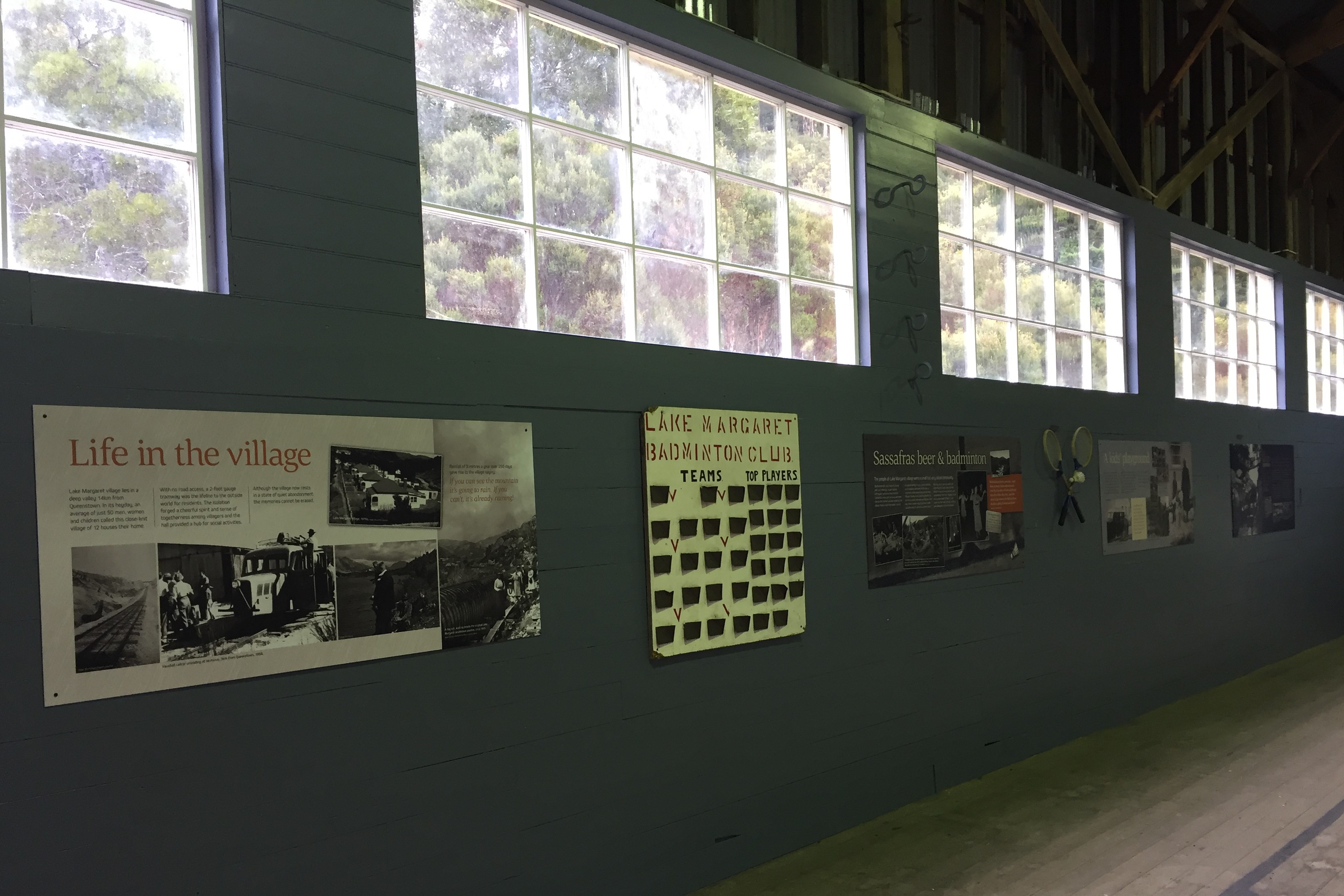 A wall with interpretation panels depicting early images and stories from Lake Margaret