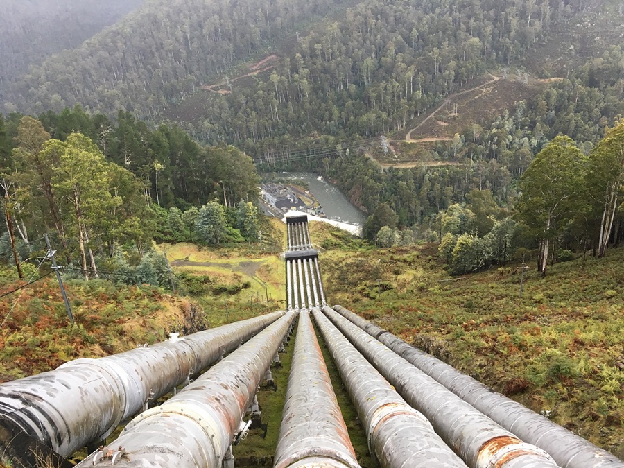 Six penstocks running down a steep hill to a power station