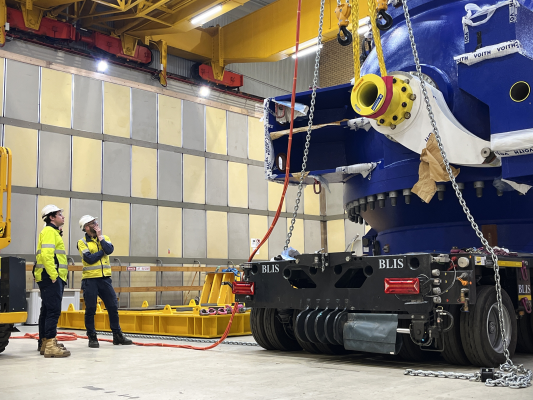 Two men looking at a main inlet valve