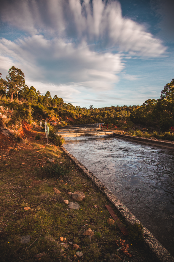 Canal full of water with blue sky in the background