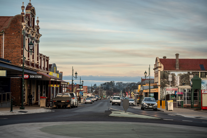 Image of a street showing buildings and cars on the road