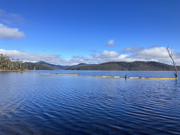 Looking over a lake with mountains and blue sky in the background