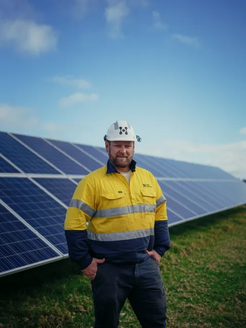Man standing in front of solar panels