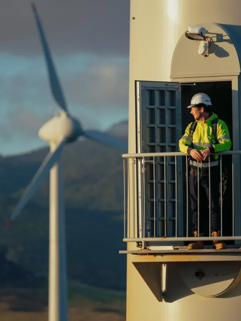 Worker in high vis standing inside wind turbine
