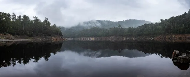 Misty lake with landscape behind