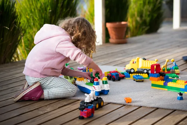 Child playing with Lego