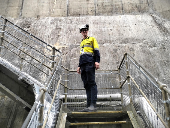 A man wearing hi vis standing on some stairs