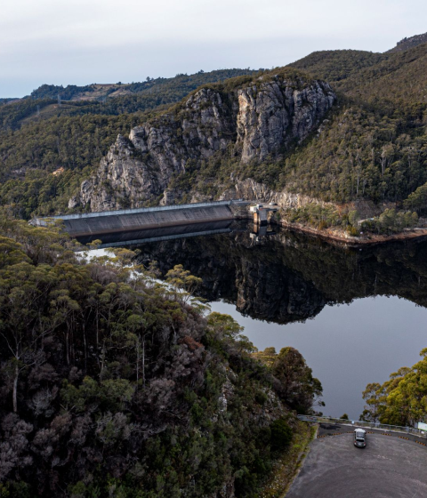 Dam surround by forest with cloudy skies