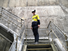 A man wearing hi vis standing on some stairs